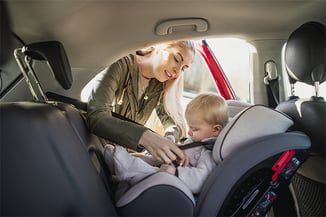 Woman following Wisconsin car seat laws