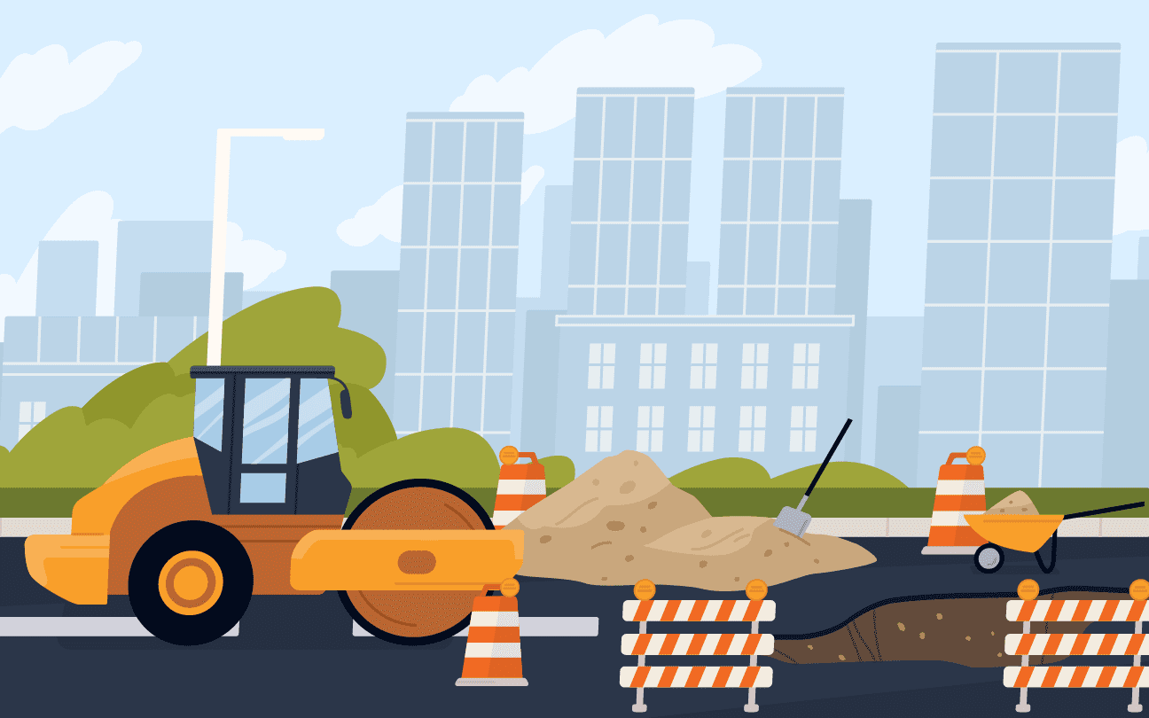 A road roller helping fill in a hole on the highway outside of a city in a road work construction zone